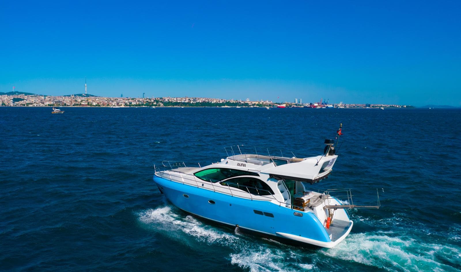 Motor yacht cruising the Bosphorus past Istanbul's waterfront