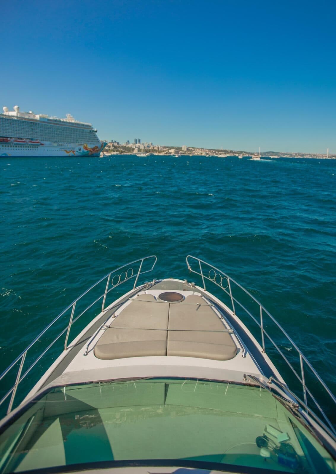 Looking over the bow of a Luma charter yacht towards a cruise ship on the Bosphorus
